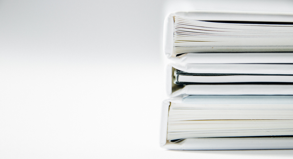 Gotcha Covered HR - Stacks of Binders on White Background - Form I-9: Requirements for Employers